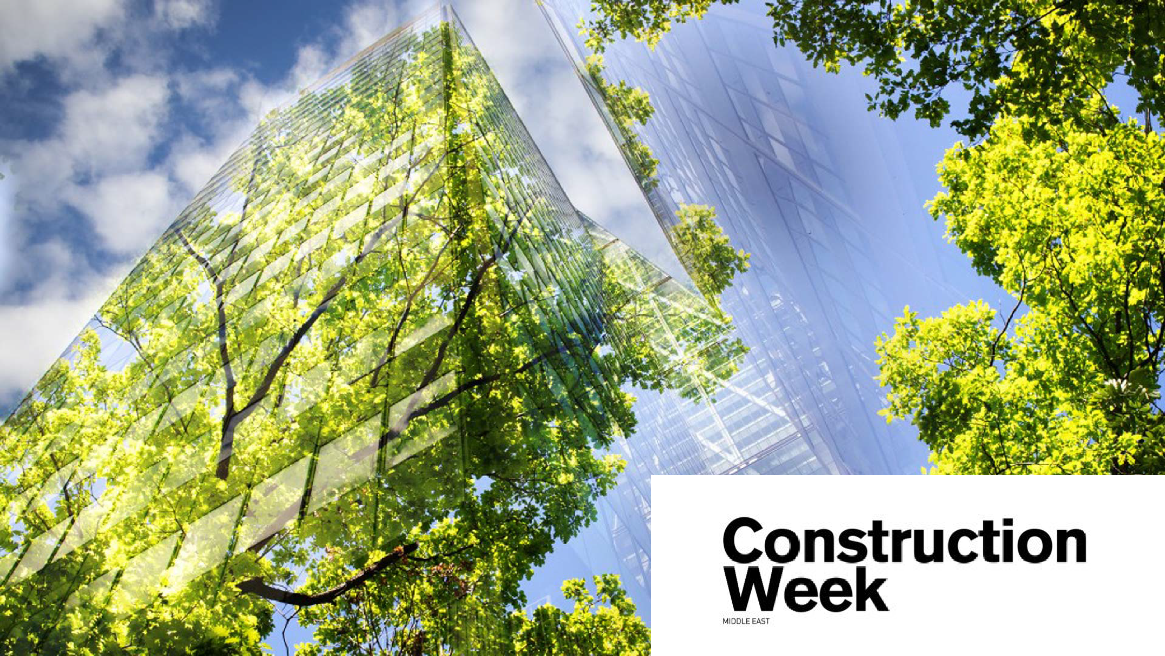 green glass building with construction week logo